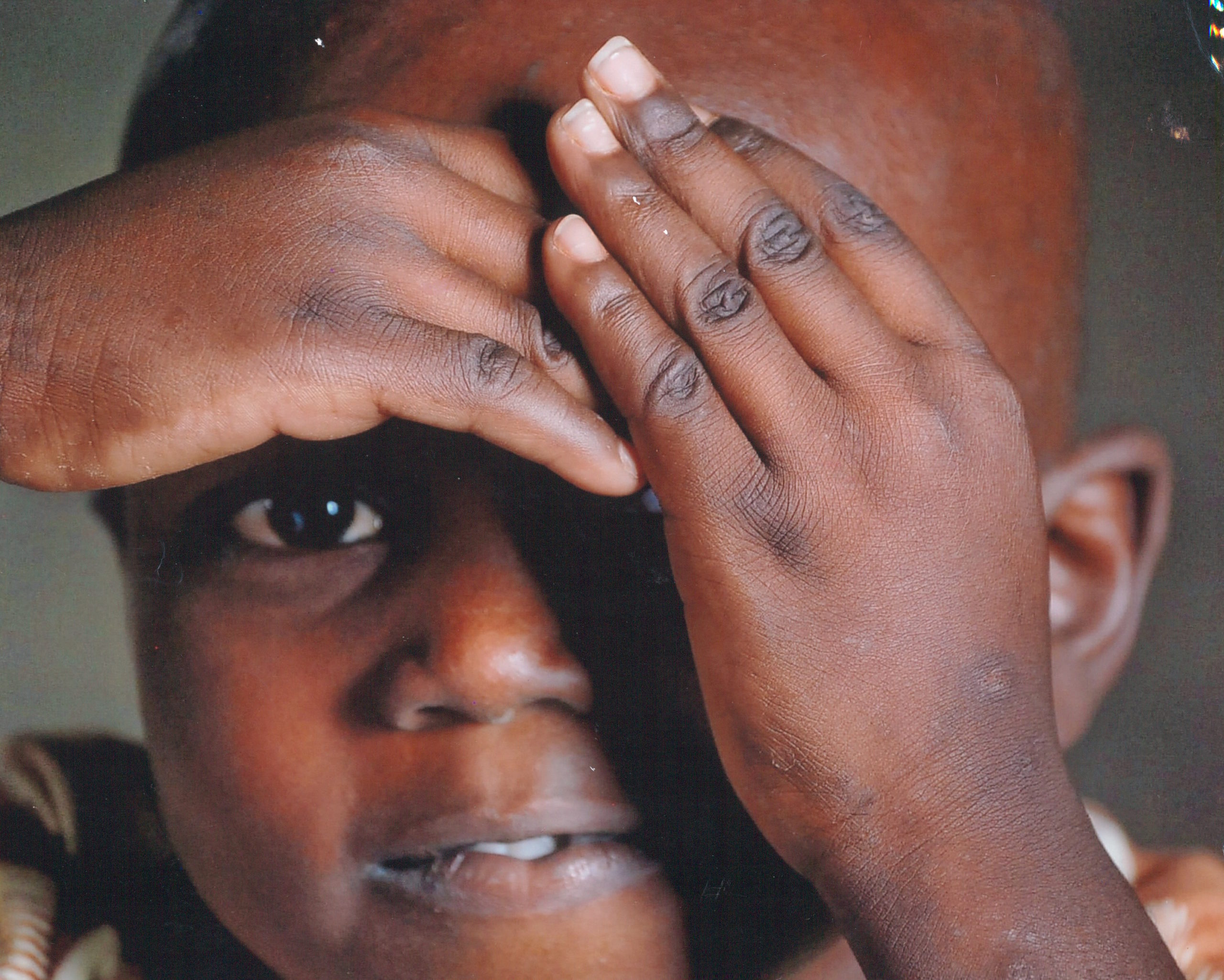 National Geographic African Boy covering eyes in Burkina Faso