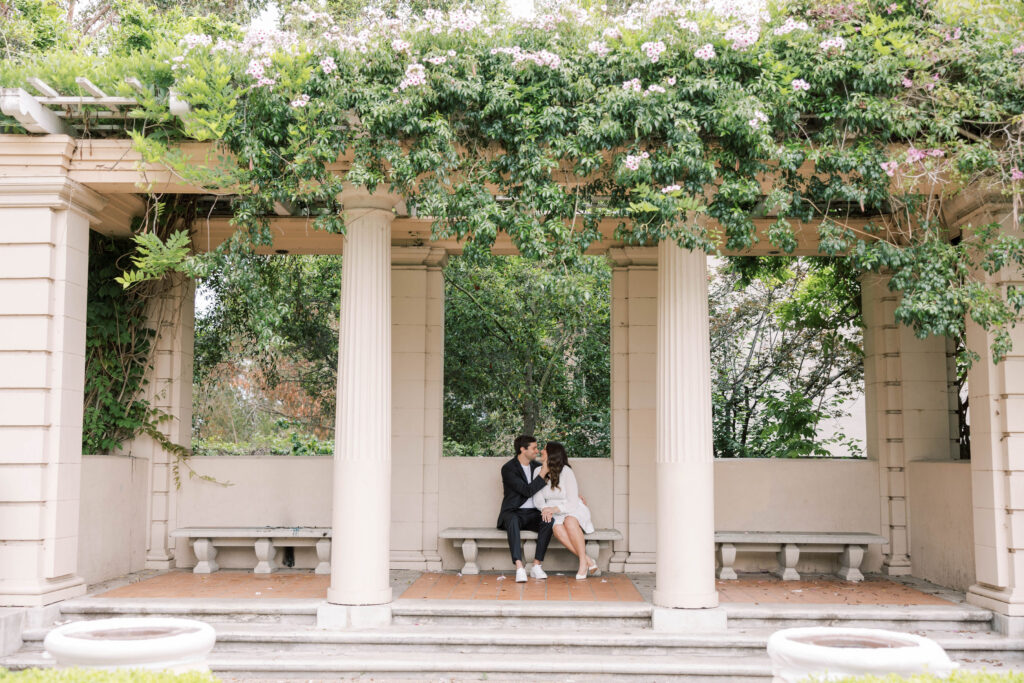 Spanish-style arches at Balboa Park, surrounded by vibrant greenery and flowers