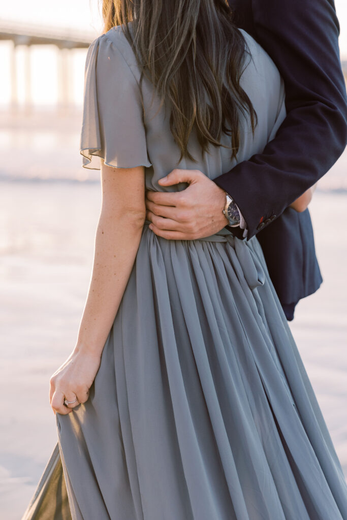 Couple walking on the sand at Scripps Pier