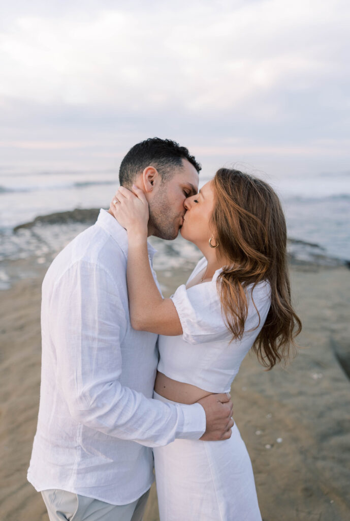 Couple kissing at Sunset Cliffs in San Diego