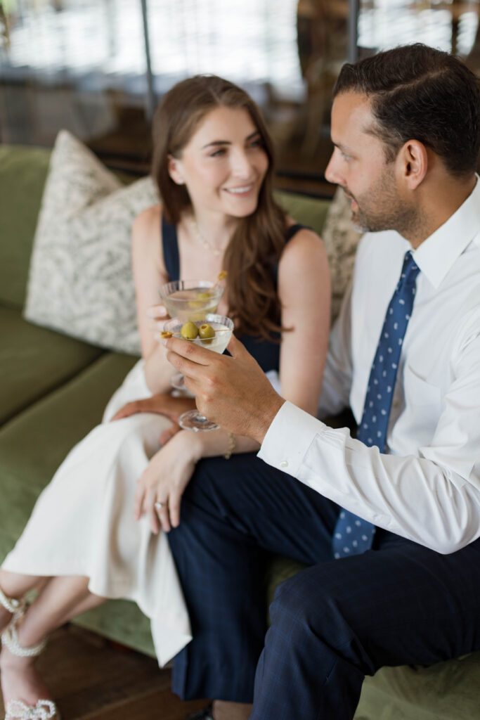 Couple share cocktails on a vintage sofa at The Inn at Rancho Santa Fe