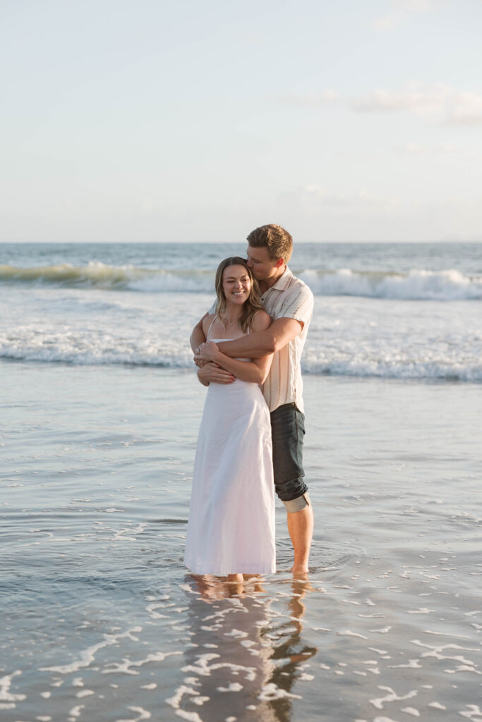 Couple embracing in the ocean at Coronado