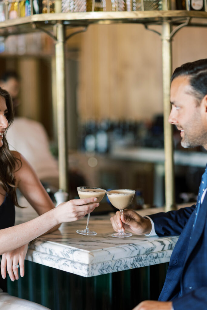 Engaged couple toasting with cocktails at the bar of The Inn at Rancho Santa Fe