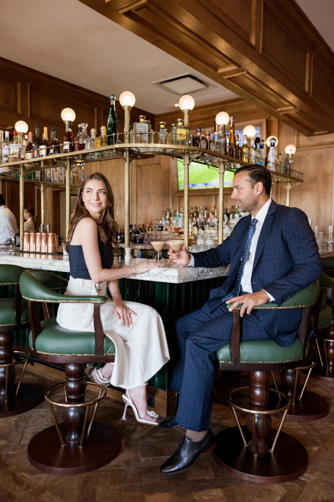 Engaged couple toasting with cocktails at the elegant bar of The Inn at Rancho Santa Fe