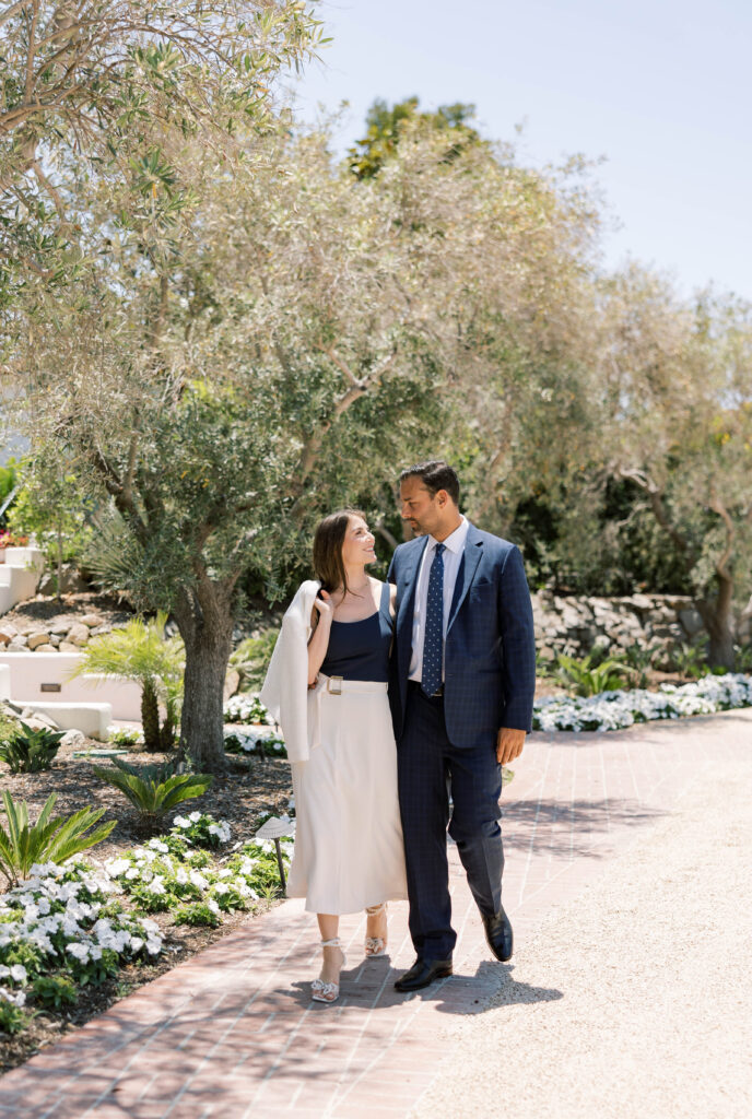 Engaged couple walking outside of The Inn at Rancho Santa Fe