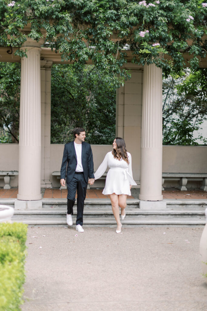 Engaged couple holding hands at Alcazar Garden in Balboa Park