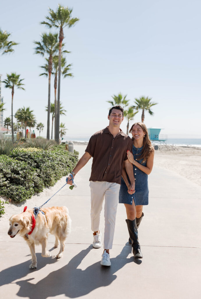 Couple and dog walking at Hotel Del Coronado proposal photo session