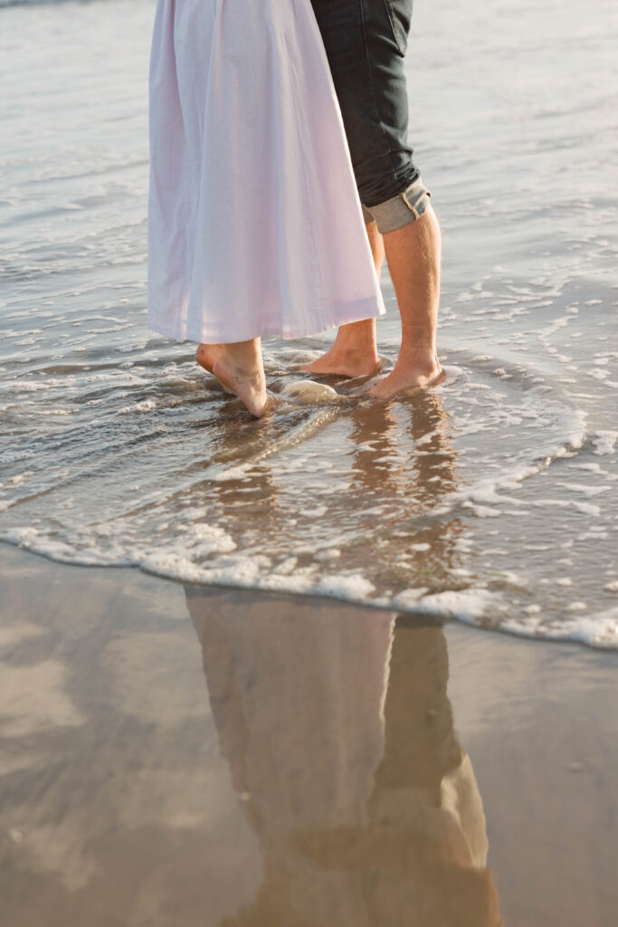 Reflection of a couple in the water at Coronado Sand Dunes engagement session