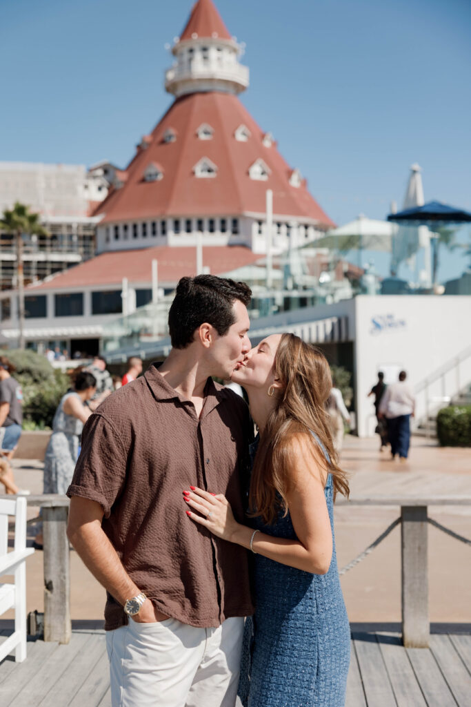Newly engaged couple kissing at Hotel Del Coronado