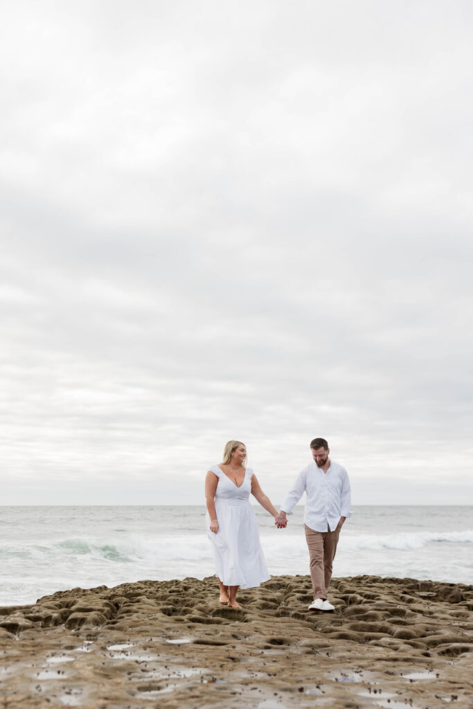 Couple holding hands at Sunset Cliffs in San Diego