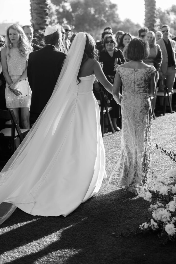 Bride walks down the aisle with mother at Park Hyatt Aviara wedding ceremony