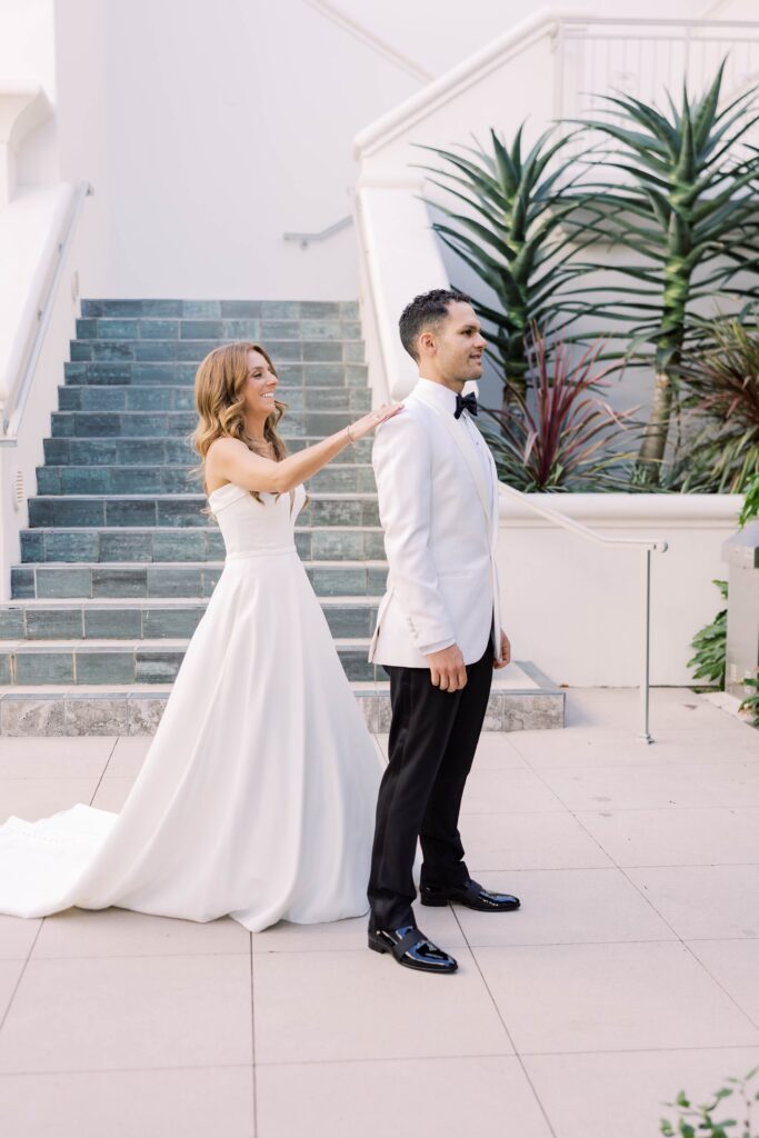 Bride tapping groom in first look photo at Park Hyatt Aviara