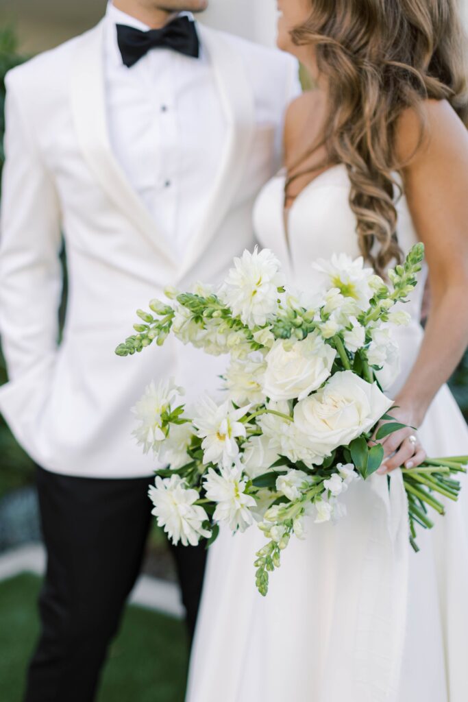 Bride and groom with bouquet at Park Hyatt Aviara in San Diego