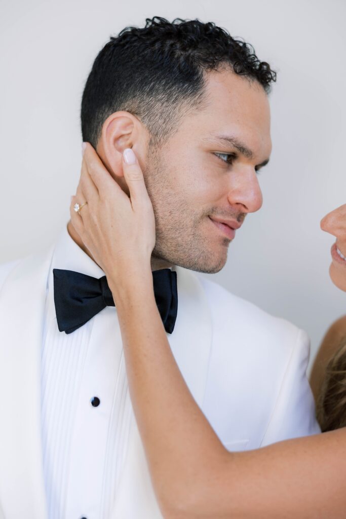 Bride holds grooms face at Park Hyatt Aviara