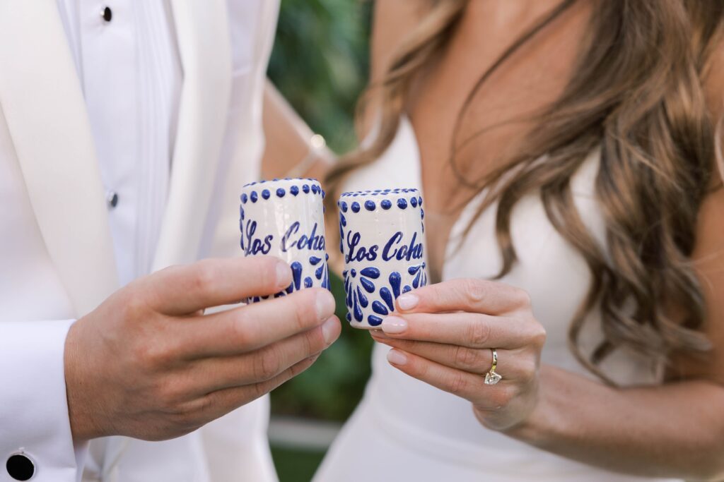 Bride and groom holding shot glasses at Park Hyatt Aviara