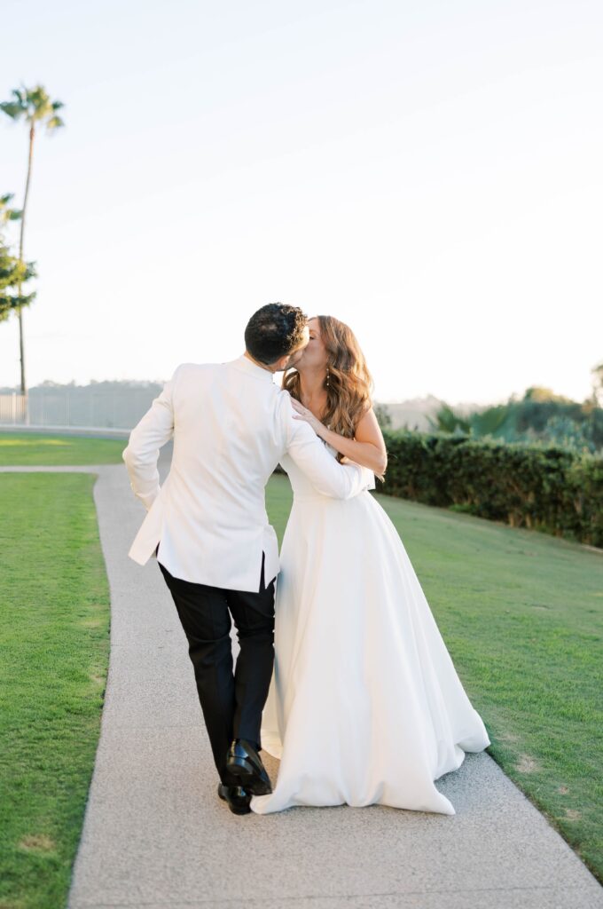 Bride and groom kiss at Park Hyatt Aviara in San Diego