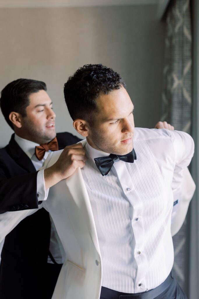 Groom getting dressed at Park Hyatt Aviara wedding