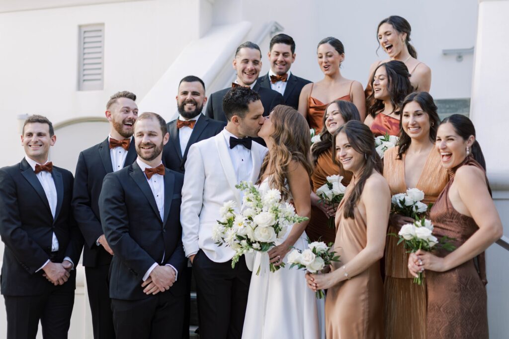 Bridal party portrait with couple kissing at Park Hyatt Aviara