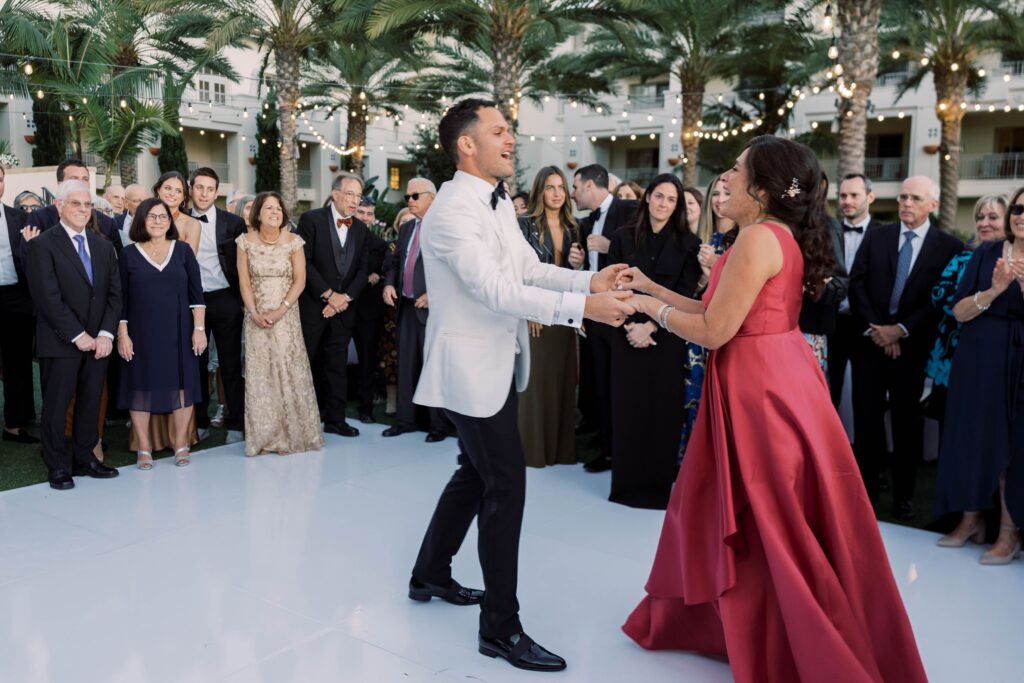 Groom and mother dance together at Park Hyatt Aviara wedding reception