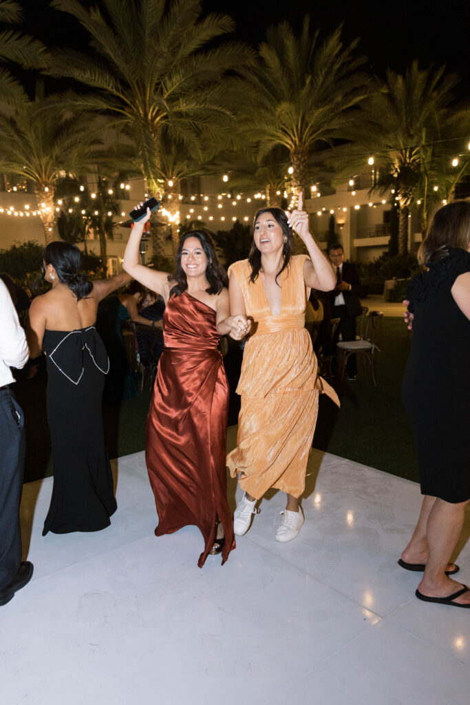 Guests dancing on dance floor at Park Hyatt Aviara wedding reception