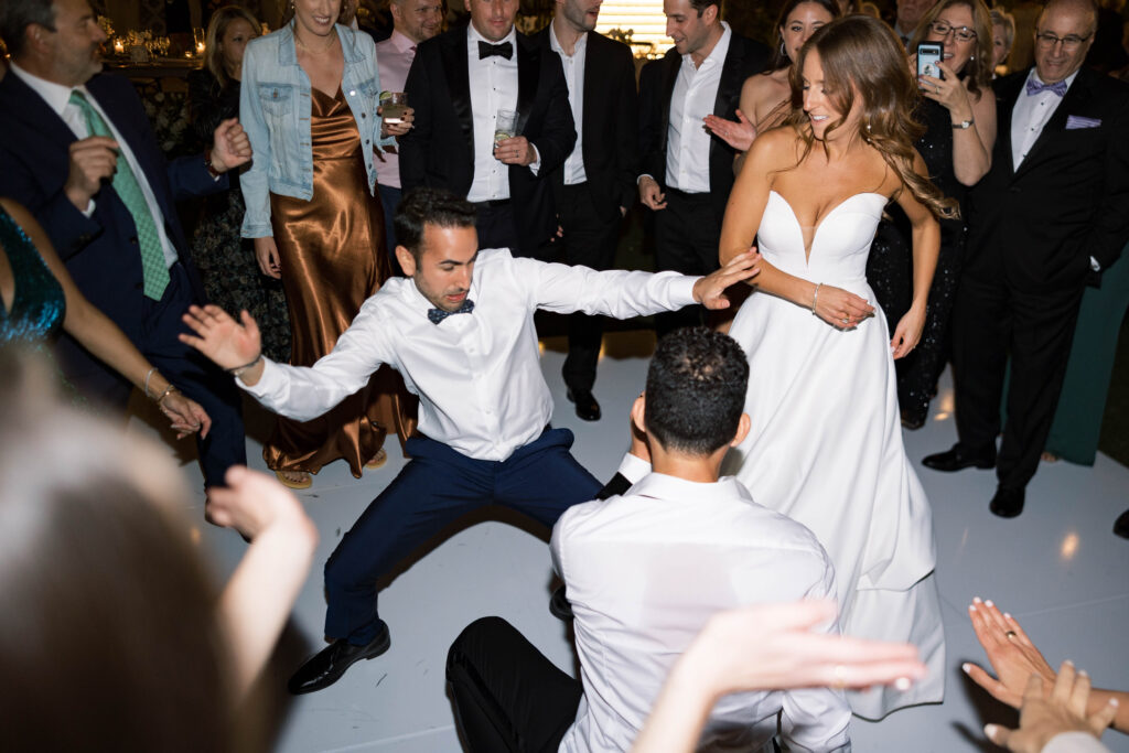Bride and guests dancing on the dance floor at Park Hyatt Aviara wedding reception
