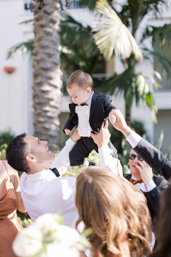 Groom dancing with baby at Park Hyatt Aviara wedding reception