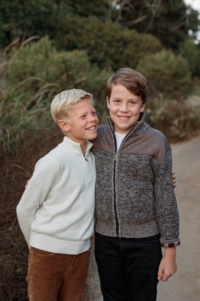 Laughing boys smile at camera at Batiquitos Lagoon