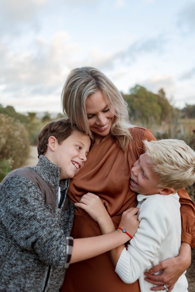 Boys and mom hug each other