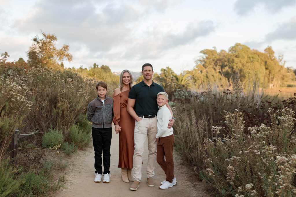 Family smiles at camera at Batiquitos Lagoon