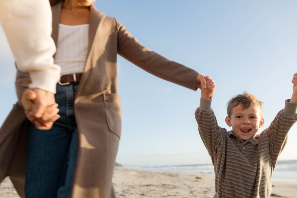 Family holds hands at Cardiff State Beach