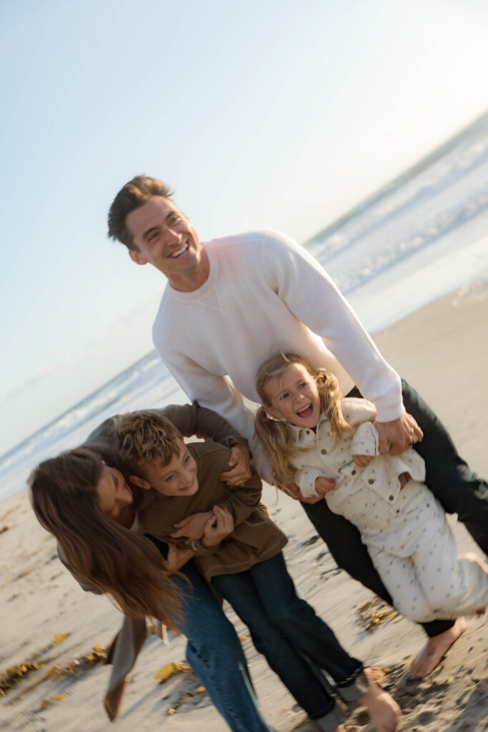 Family laughs and plays at Cardiff State Beach