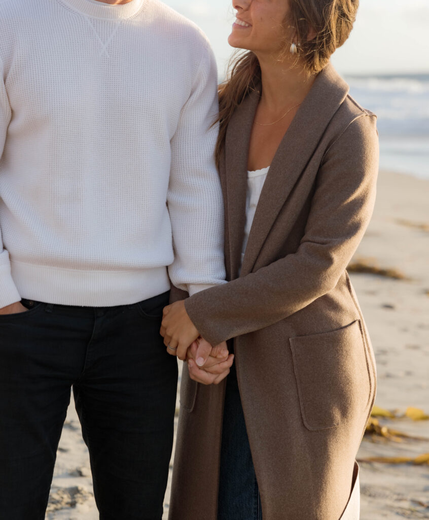 Couple holds hands at Cardiff State Beach