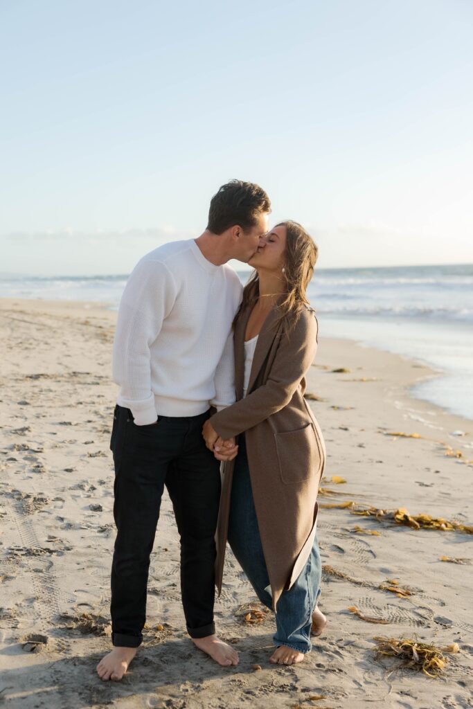 Couple kisses at Cardiff State Beach photoshoot